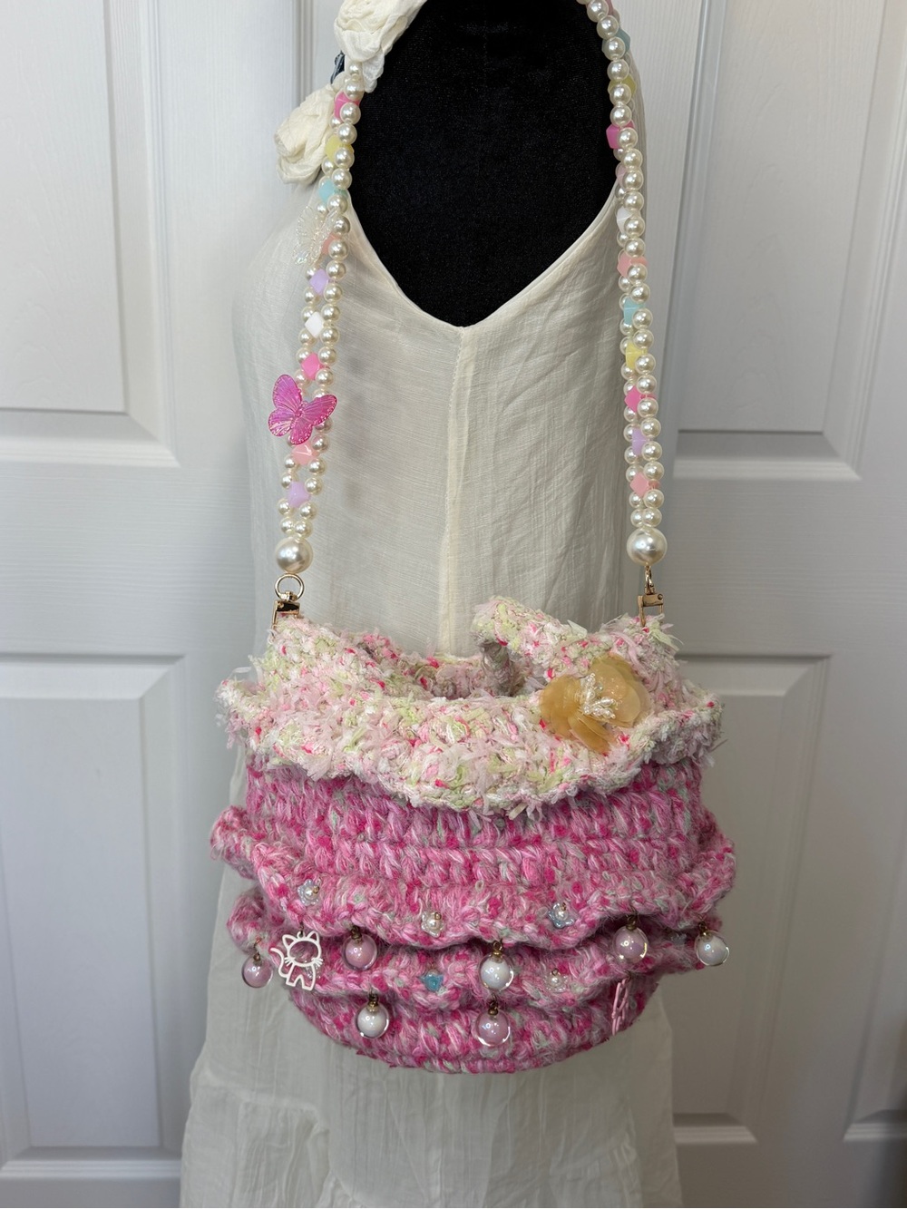 handknit pink pearl-accented tote bag